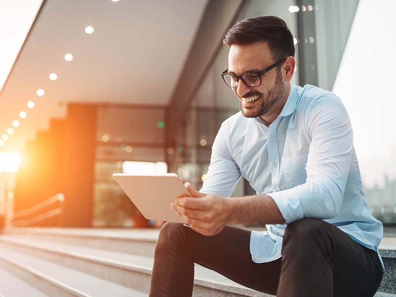 Man on tablet paying bills